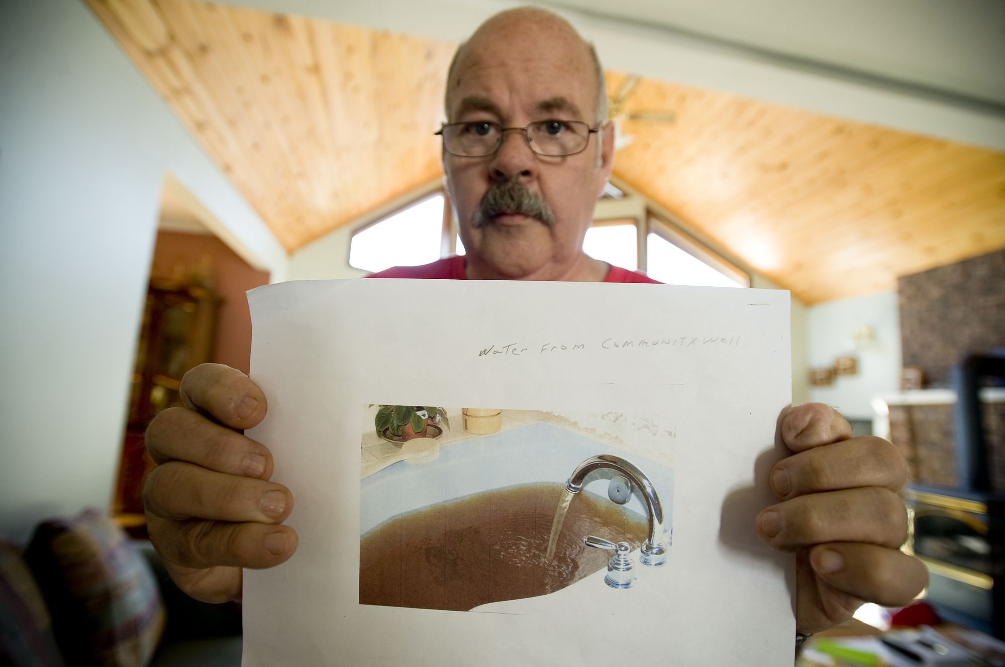 David Rogers showed Clark County commissioners this photo of his bathtub filled with well water as evidence that operation of the Yacolt Mountain Quarry has ruined his well, but commissioners say there's no proof the quarry is to blame.