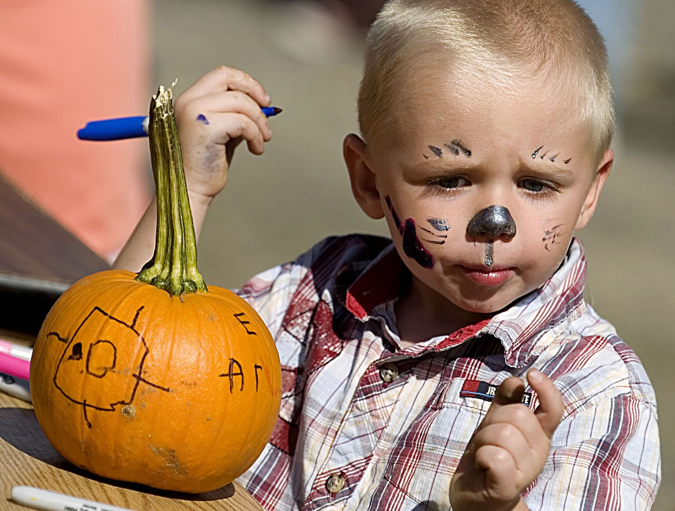 Alexander Schroeder, 3, of Vancouver, decorates a pumpkin at the Clark County Historical Museum's Harvest Fun Day in 2007.