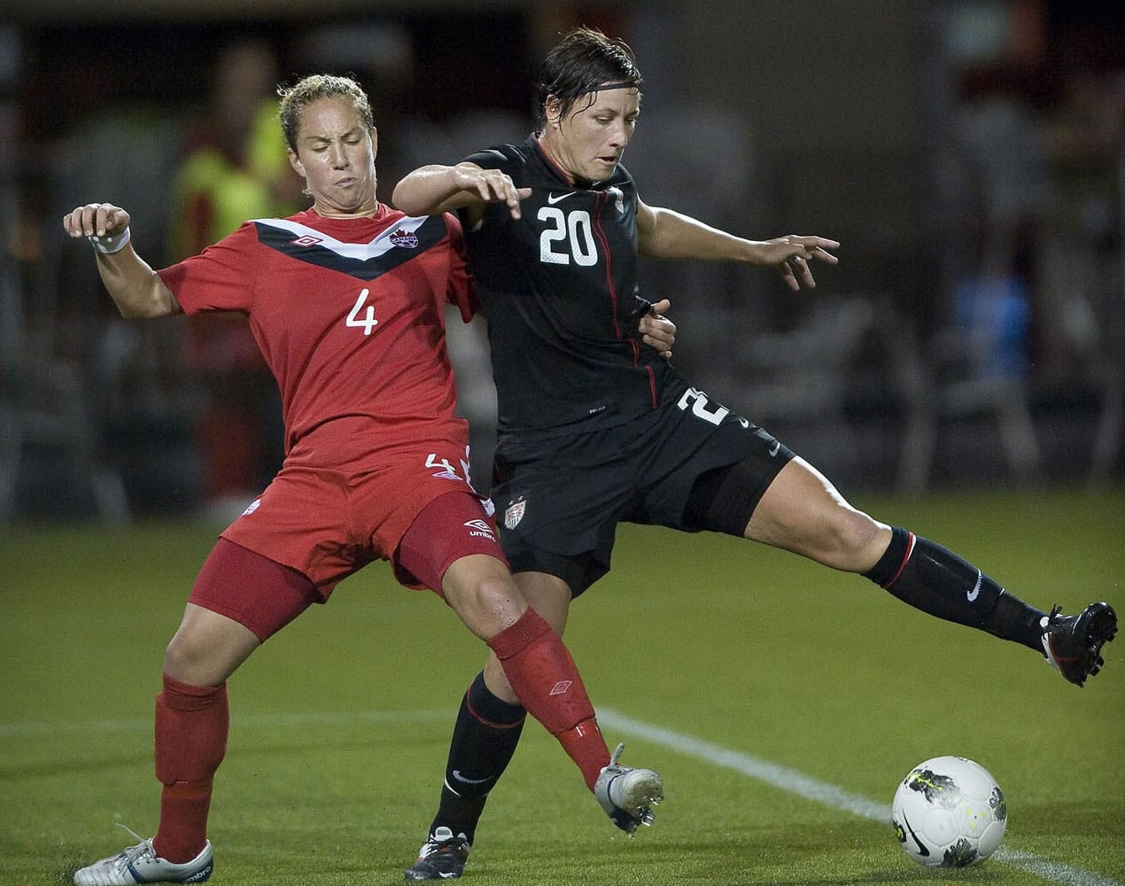 Abby Wambach battles with Canada's Carmelina Moscato in the first half at Jeld-Wen Field in Portland on Thursday.