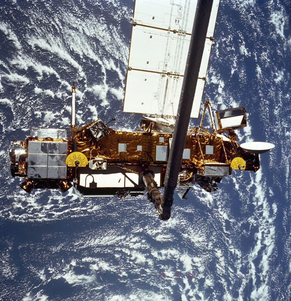 In this image provided by NASA this is the STS-48 onboard photo of the Upper Atmosphere Research Satellite (UARS) in the grasp of the RMS (Remote Manipulator System) during deployment, from the shuttle in September 1991.