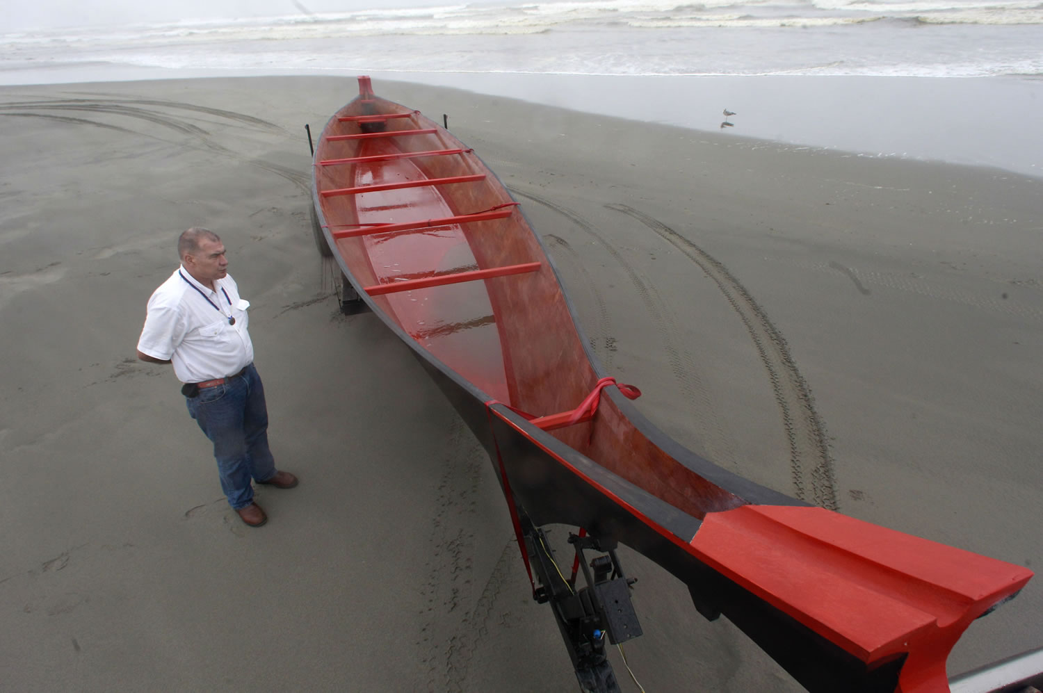 The Honorable Tribal Chairman Ray Gardner of the Chinook Indian Nation stands next to a 36-foot canoe Friday in Long Beach.