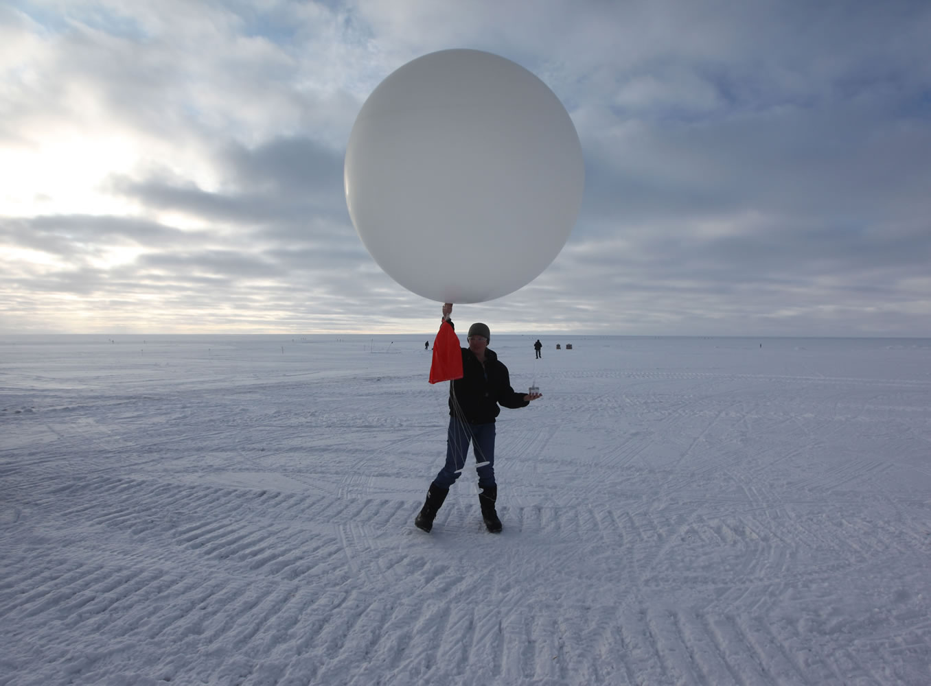 Atop roughly two miles of ice, technician Marie McLane launches a data-transmitting weather balloon July 15 at Summit Station, a remote research site operated by the U.S. National Science Foundation (NSF), and situated 10,500 feet above sea level, on top of the Greenland ice sheet.