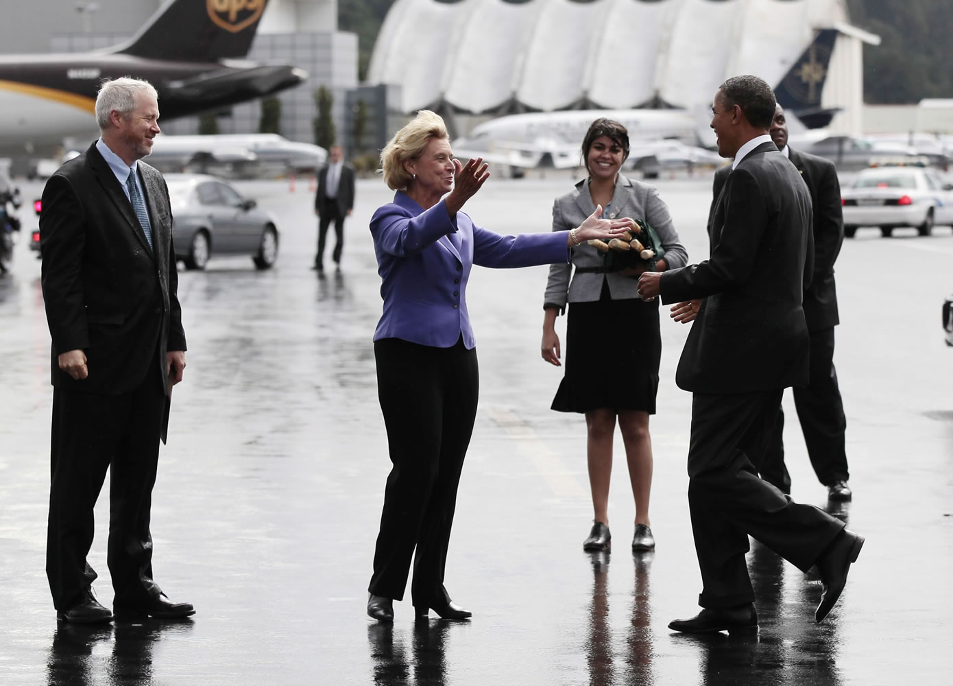 President Barack Obama, right, is greeted with open arms by Washington Gov. Chris Gregoire during his arrival at Boeing Field Sunday in Seattle.