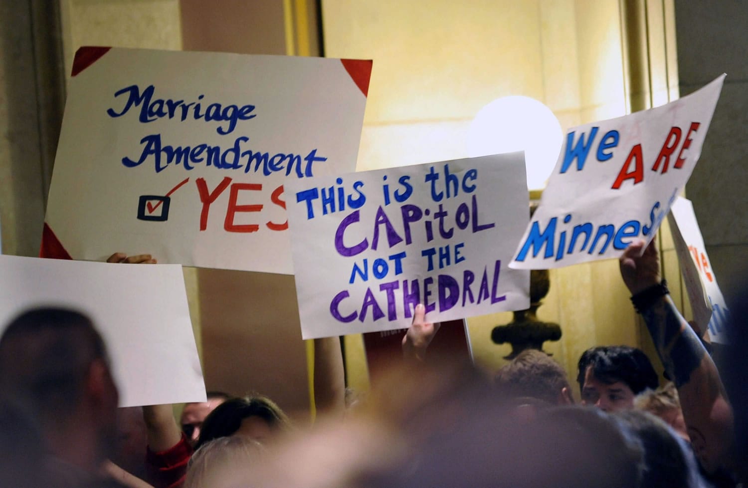 On this May 19, 2011 file photo, demonstrators on both sides of the gay marriage issue gathered outside the Minnesota House in St. Paul, Minn. The Census Bureau reports there are 131,729 same-sex couples in the U.S. who say they're married _ the first-ever government count of this kind.