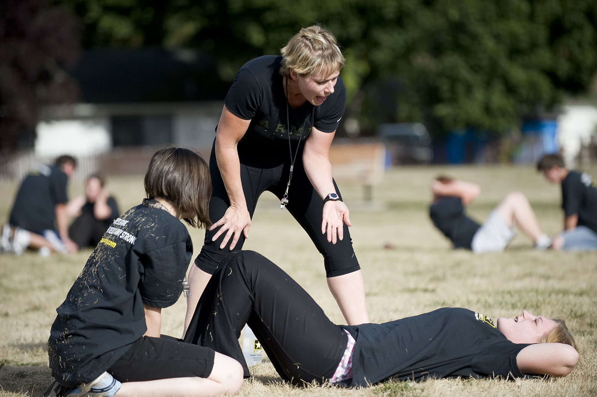 Pfc. Lee Kershaw, center, works with new recruits Ranee Watkins, 23, left, and Renee Costello, 20, during the physical training Thursday. Kershaw volunteers her time once a week to mentor recruits in the Army's Future Soldiers program.