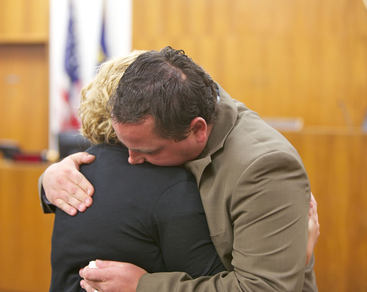 Dale Hickman and his wife, Shannon, embrace after Dale's testimony in Clackamas County Circuit Court in Oregon City, Ore.