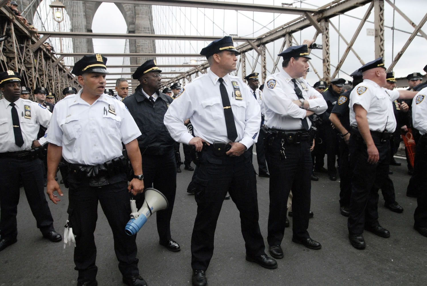 Police turn to face the front line of protesters Saturday who walked behind them about one third of the way onto New York's Brooklyn Bridge before police began making arrests during Saturday's march by Occupy Wall Street. Protesters speaking out against corporate greed and other grievances attempted to walk over the bridge from Manhattan, resulting in the arrest of more than 700 during a tense confrontation with police.