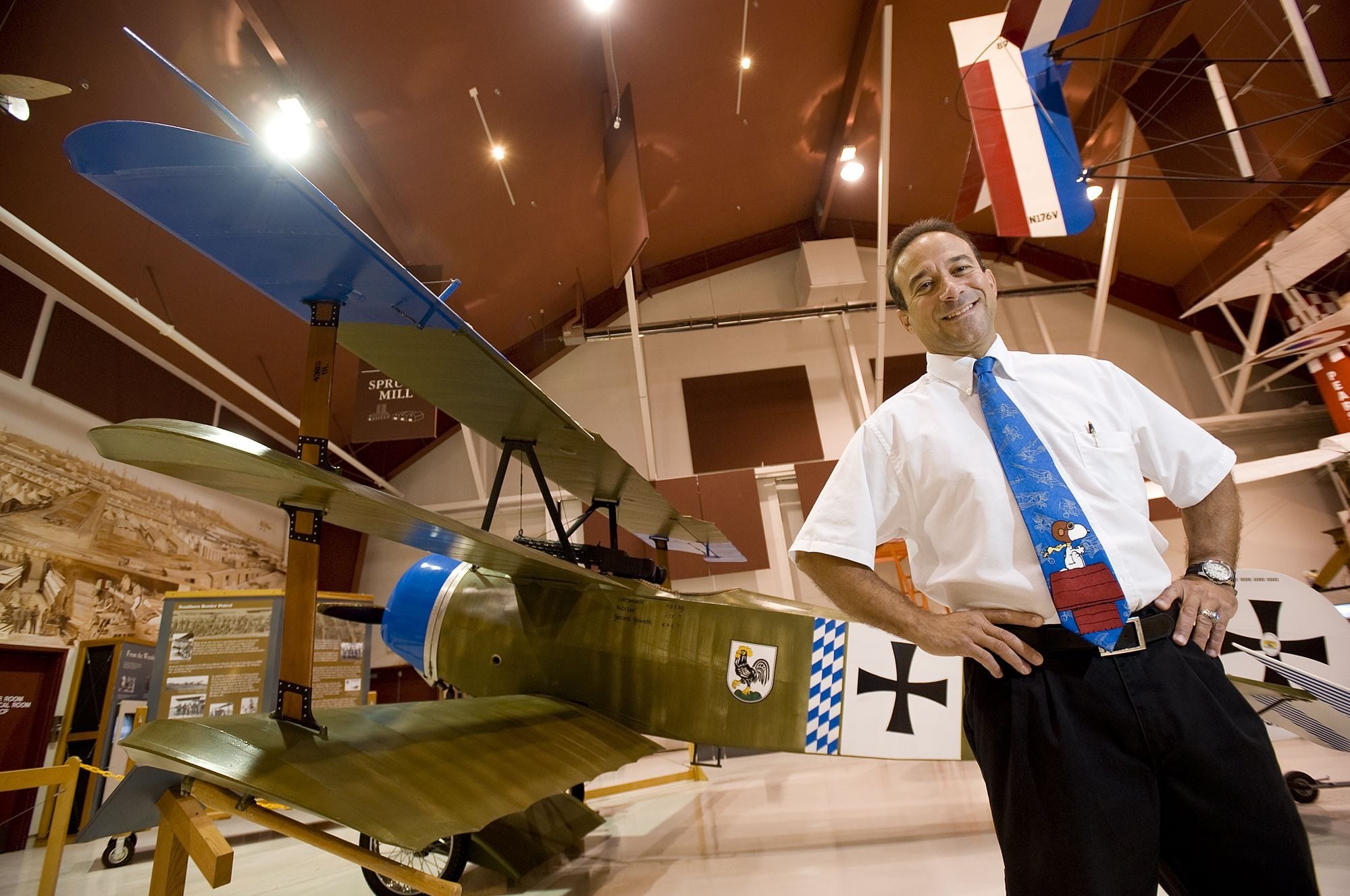 Laureano Mier, Pearson Air Museum manager, stands in front of a replica Fokker triplane that will be one of two on display Saturday during a special program on World War I.