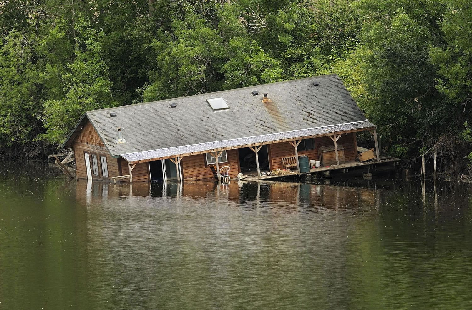 An abandoned houseboat, here in July, was moved off the bank of the Lake River near Ridgefield last year.
