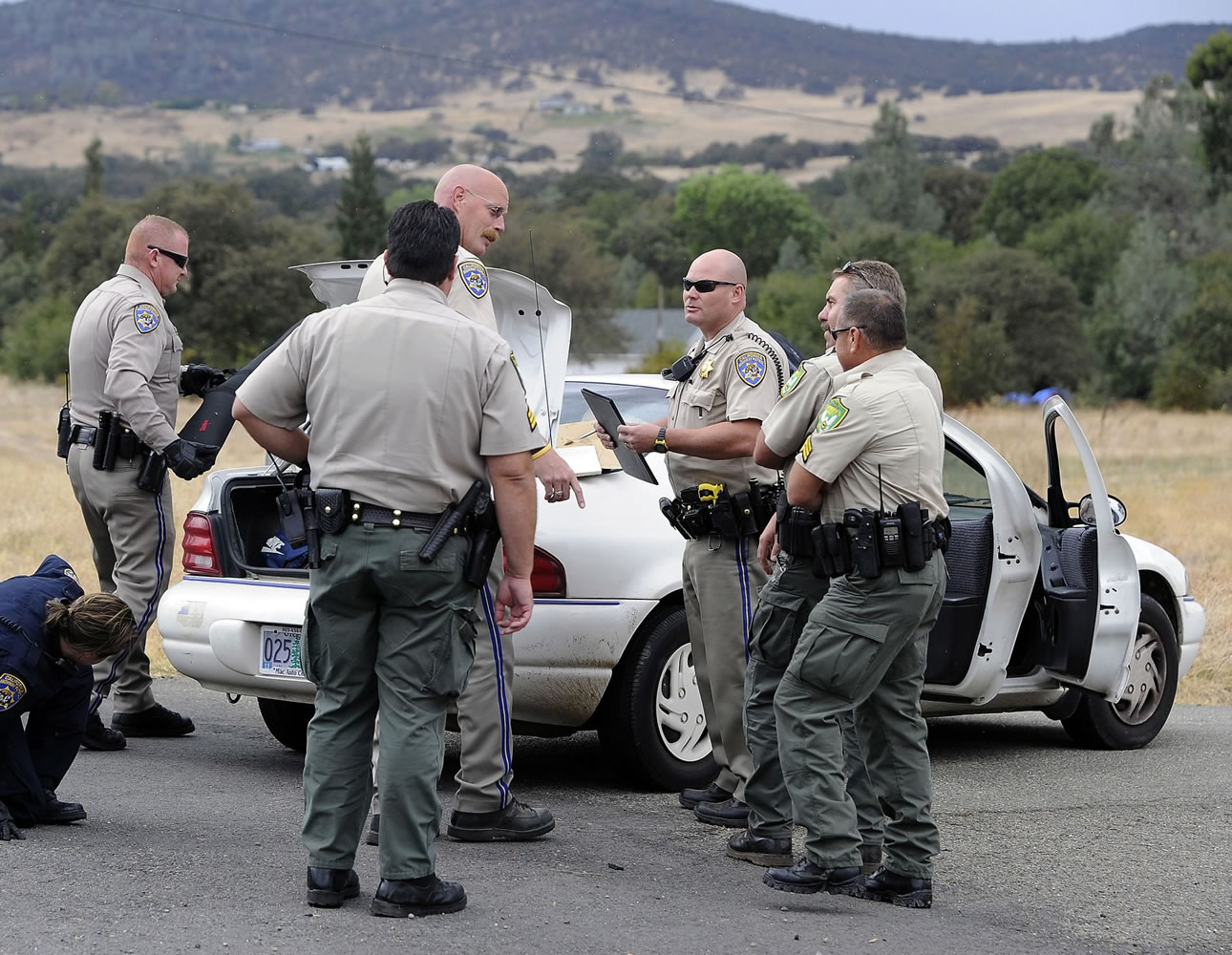 Law enforcement officials check out a vehicle Wednesday following a traffic stop and the arrest of murder suspects David Joseph Pedersen and Holly Ann Grigsby near Yuba City, Calif.