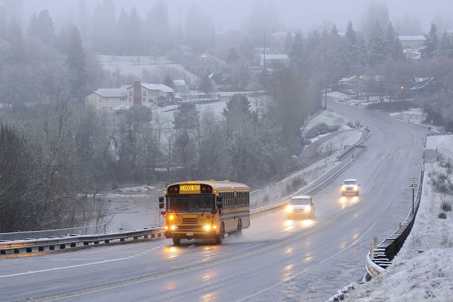 A Vancouver School District School bus makes its way across Salmon Creek along NW 36th Ave. Tuesday March 1, 2011 in Vancouver, Washington.