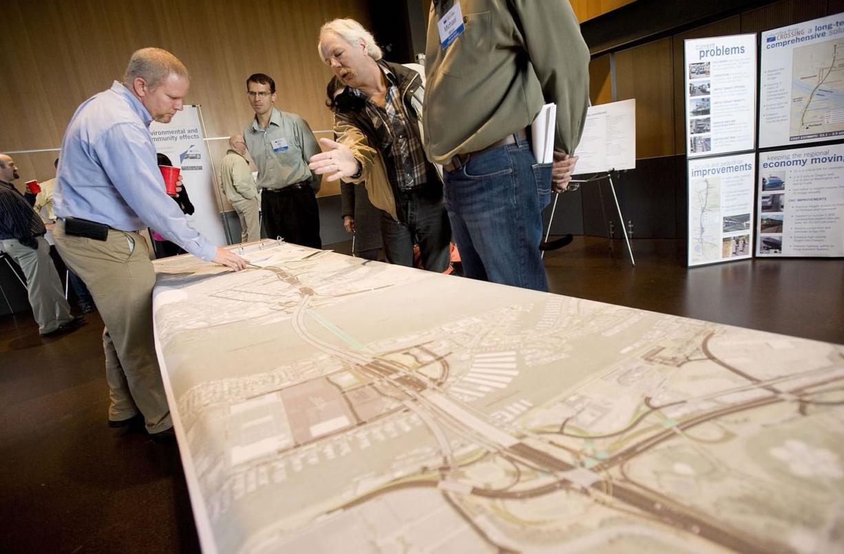 Columbia River Crossing engineering manager Casey Liles, left, answers a question during one of two open houses Wednesday at the Vancouver Community Library.