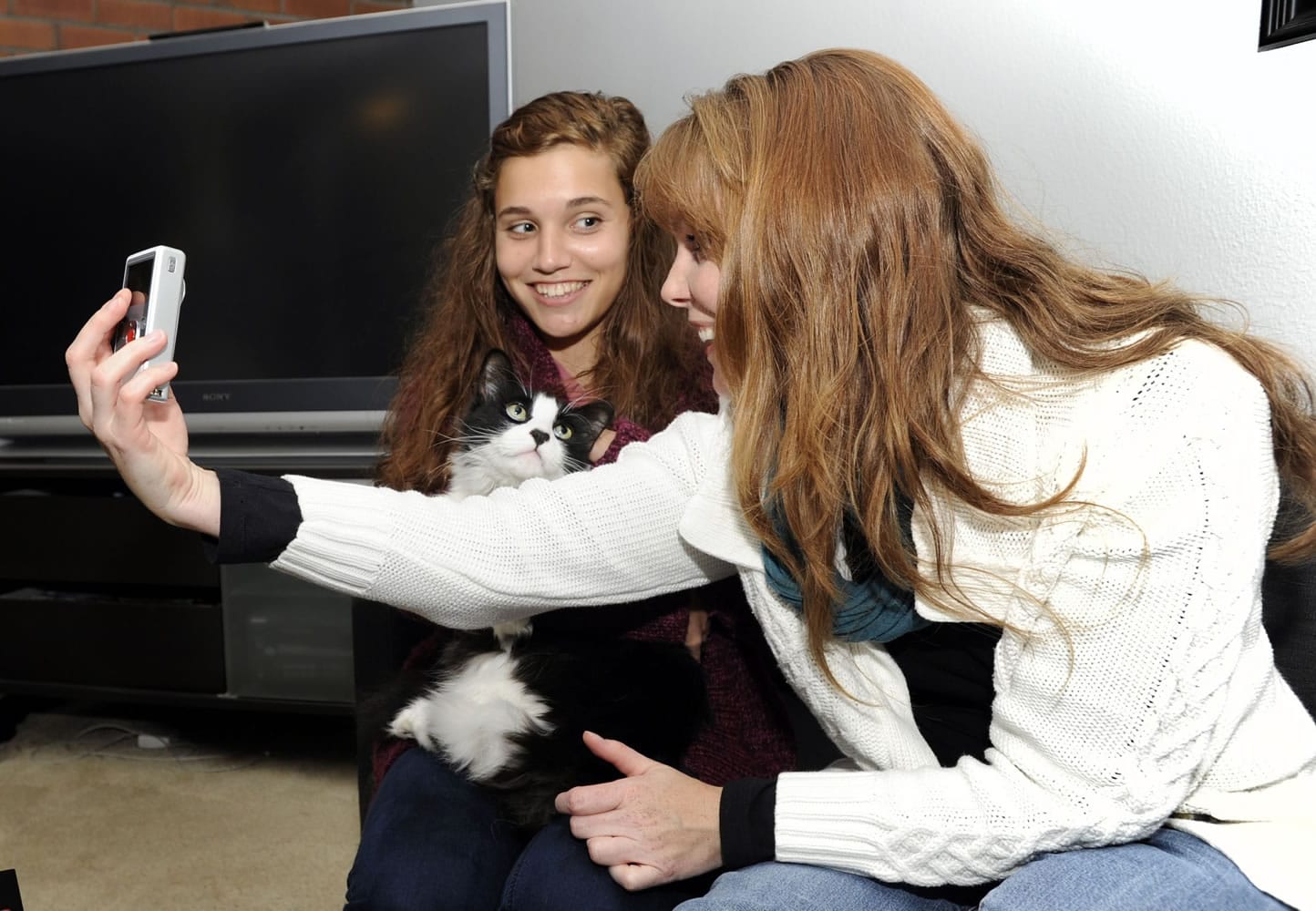 Sunshine, holding Lex Luthor the cat on the left, and her mother, Mercedes Rose, collaborate as they prepare for a filming session for their Web series &quot;The Haunting of Sunshine Girl.&quot; The series has grown a strong cult following since it began in December 2010.