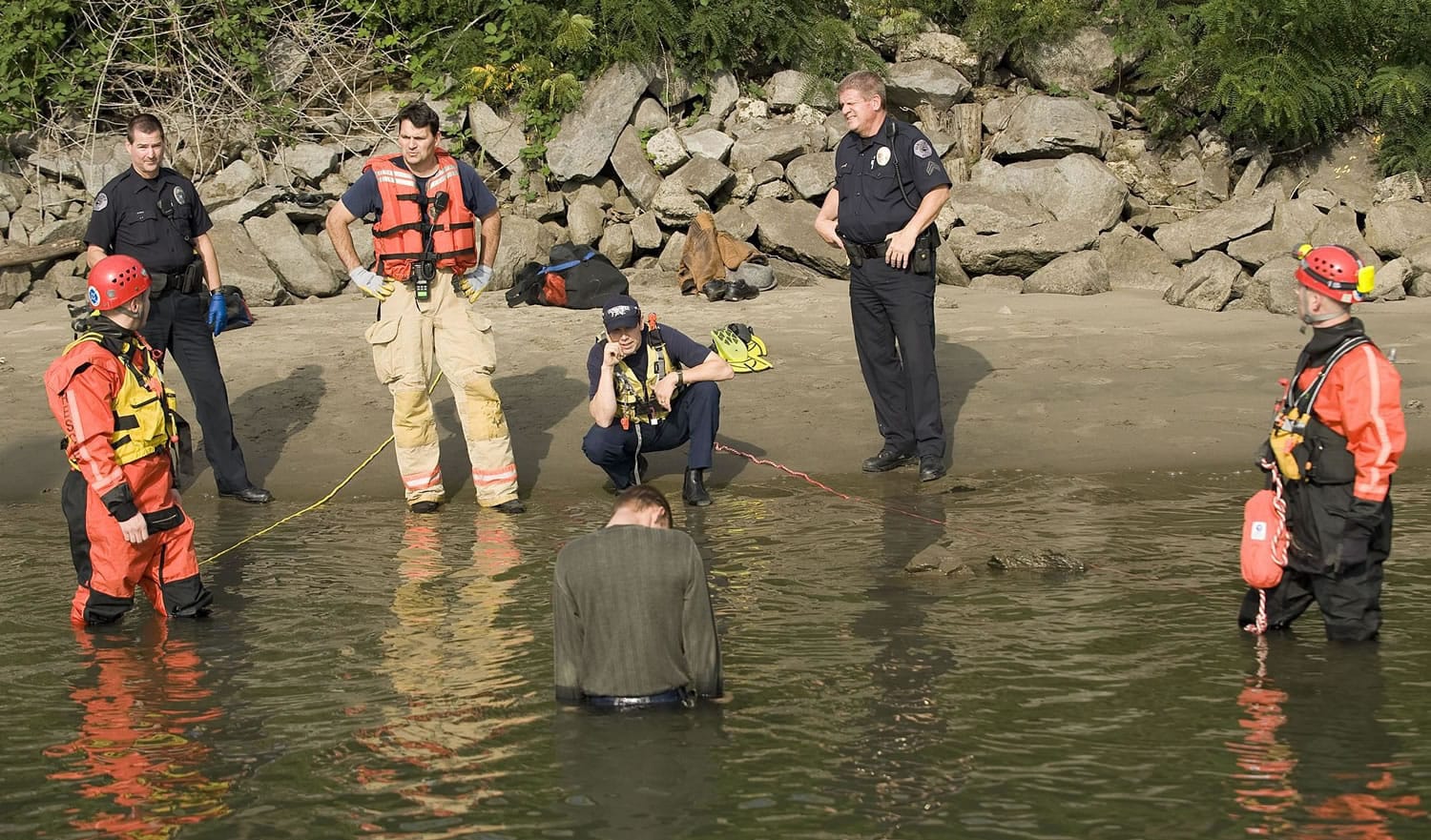 Police, firefighters and paramedics respond to a man standing in the Columbia River near the boat dock adjacent the Red Lion Hotal at the Quay.