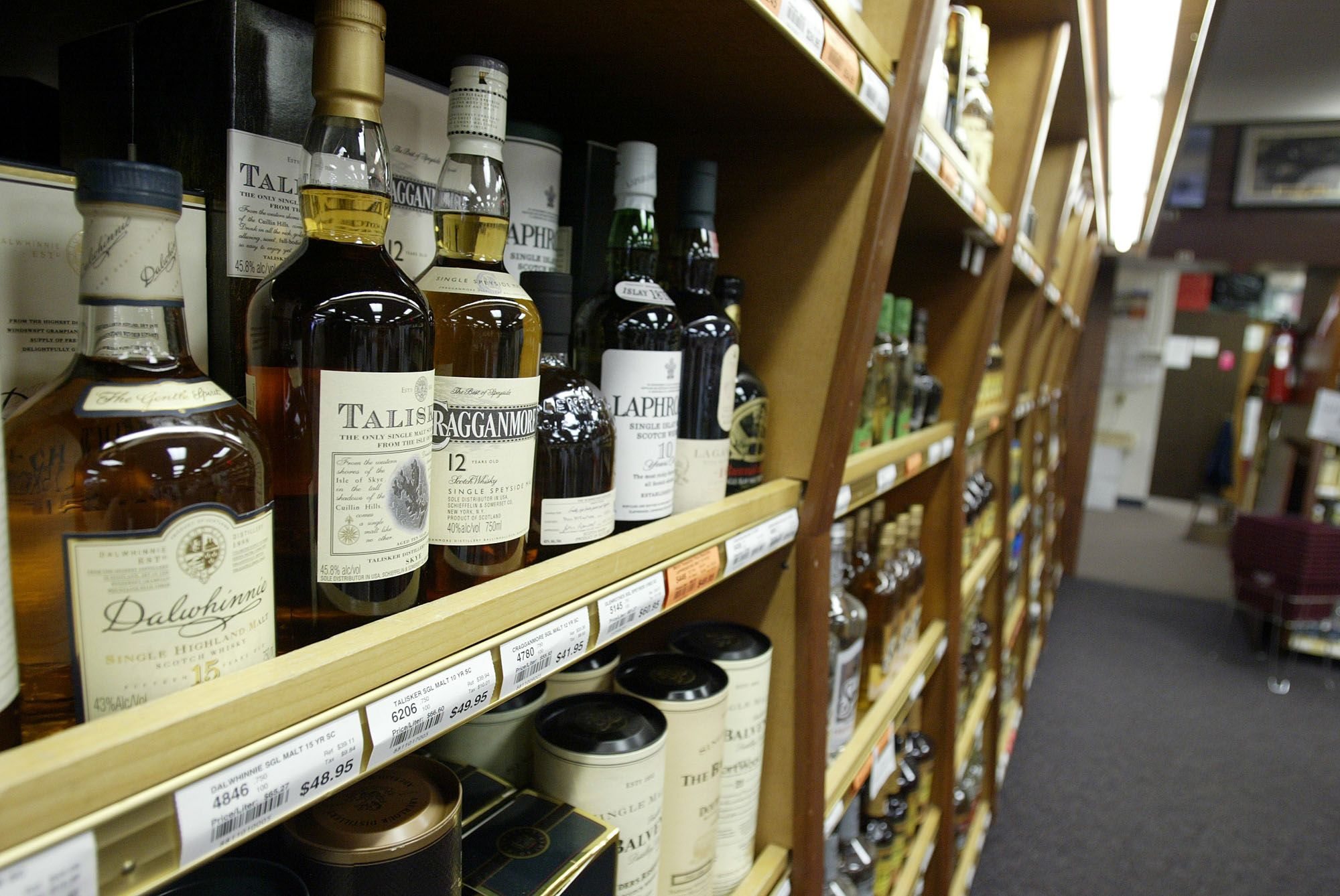 Bottles of scotch sit on a shelf at a state liquor store in Tumwater.