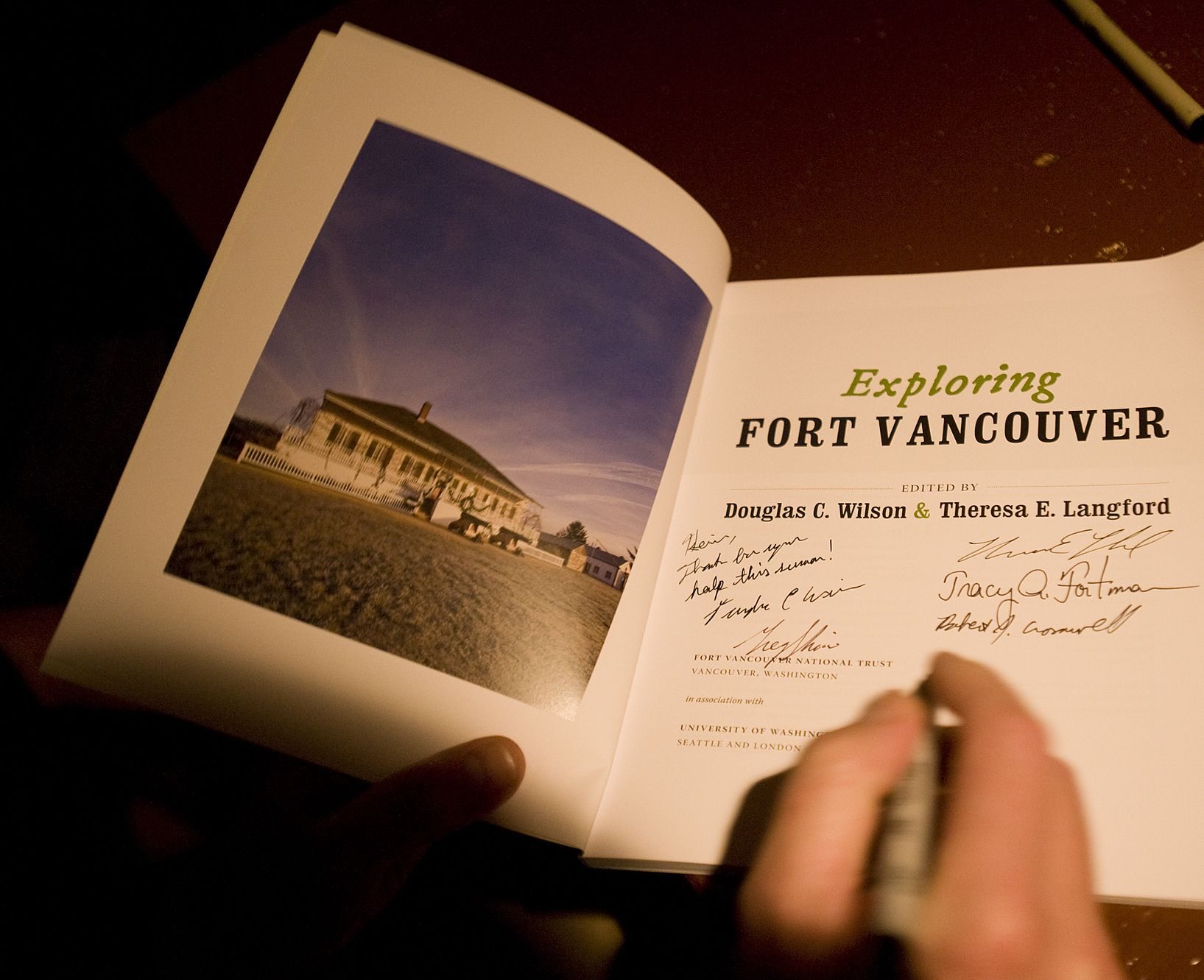 Contributors autograph &quot;Exploring Fort Vancouver&quot; during an Oct.