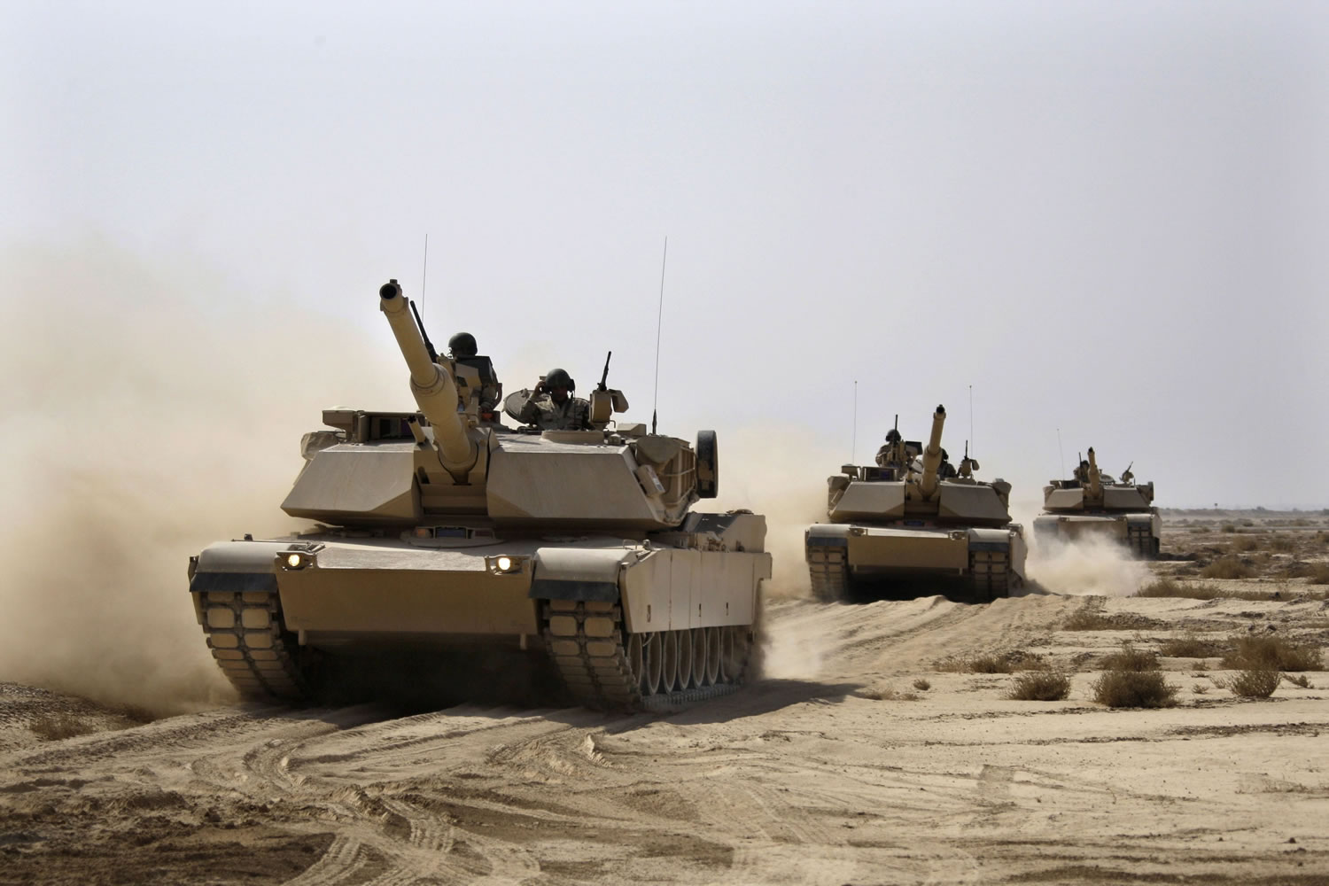 Iraqi Army M1A1 Abrams tanks, purchased from the United States, maneuver during a live-fire exercise Tuesday outside Baghdad. With the U.S.