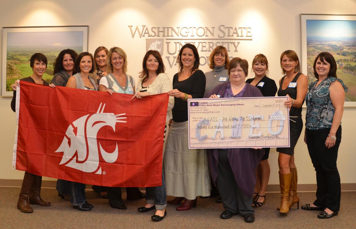 Cathy Anna Mayer Encouraging Others members received a Campaign for Washington State University flag as thanks for their support of the At Home At School program at WSU Vancouver.