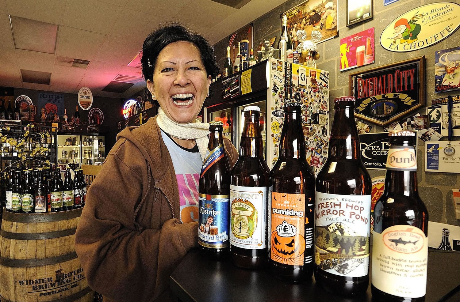 Arlene Nunez, owner of By the Bottle, shows off a selection of fall beers at her store.