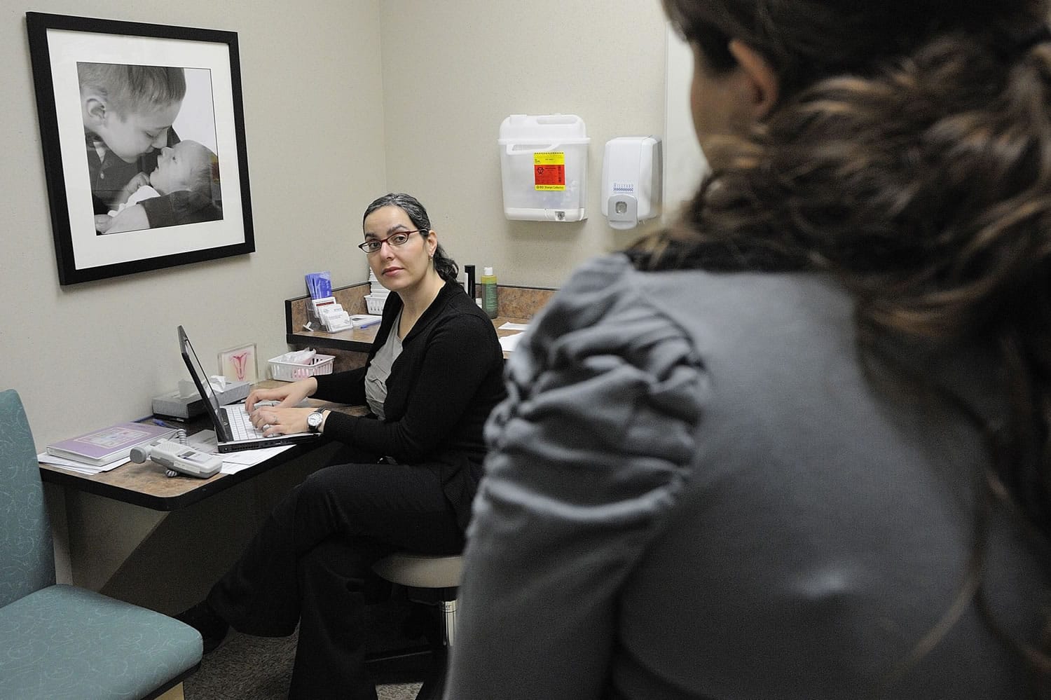 Dr. Karen Rosenblum listens to patient Yudmila Kononenko during a routine pregnancy examination at The Vancouver Clinic last week.
