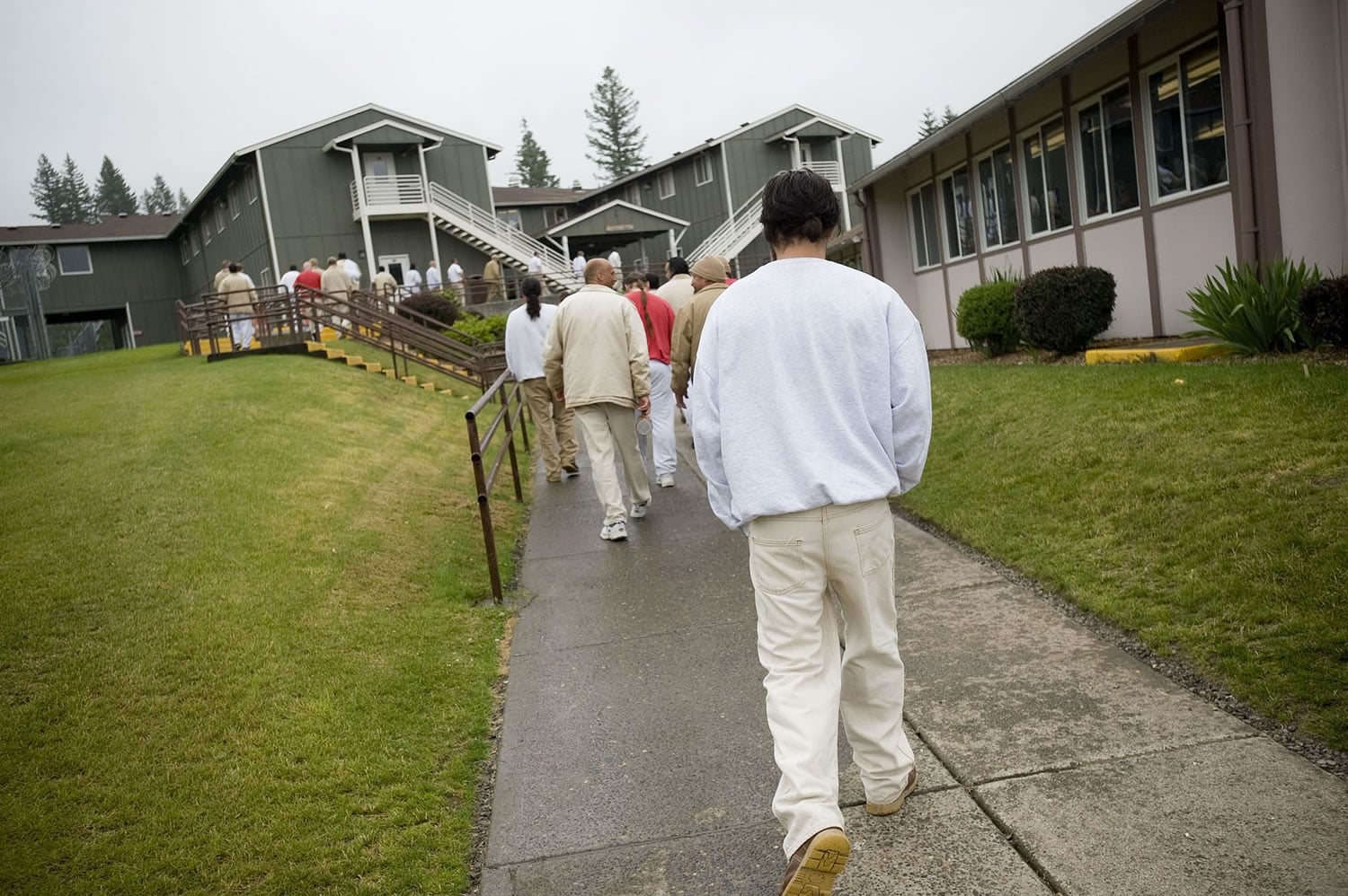 Inmates at the Larch Corrections Center walk back to the barracks earlier this year.