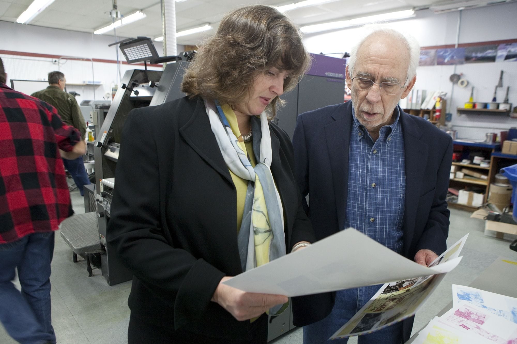 Susan Tissot, executive director of the Clark County Historical Museum, and Howard Gingold, editor of the annual &quot;Clark County History&quot; journal, watch covers roll off the press at Columbia Litho Printing and Imaging in Camas.