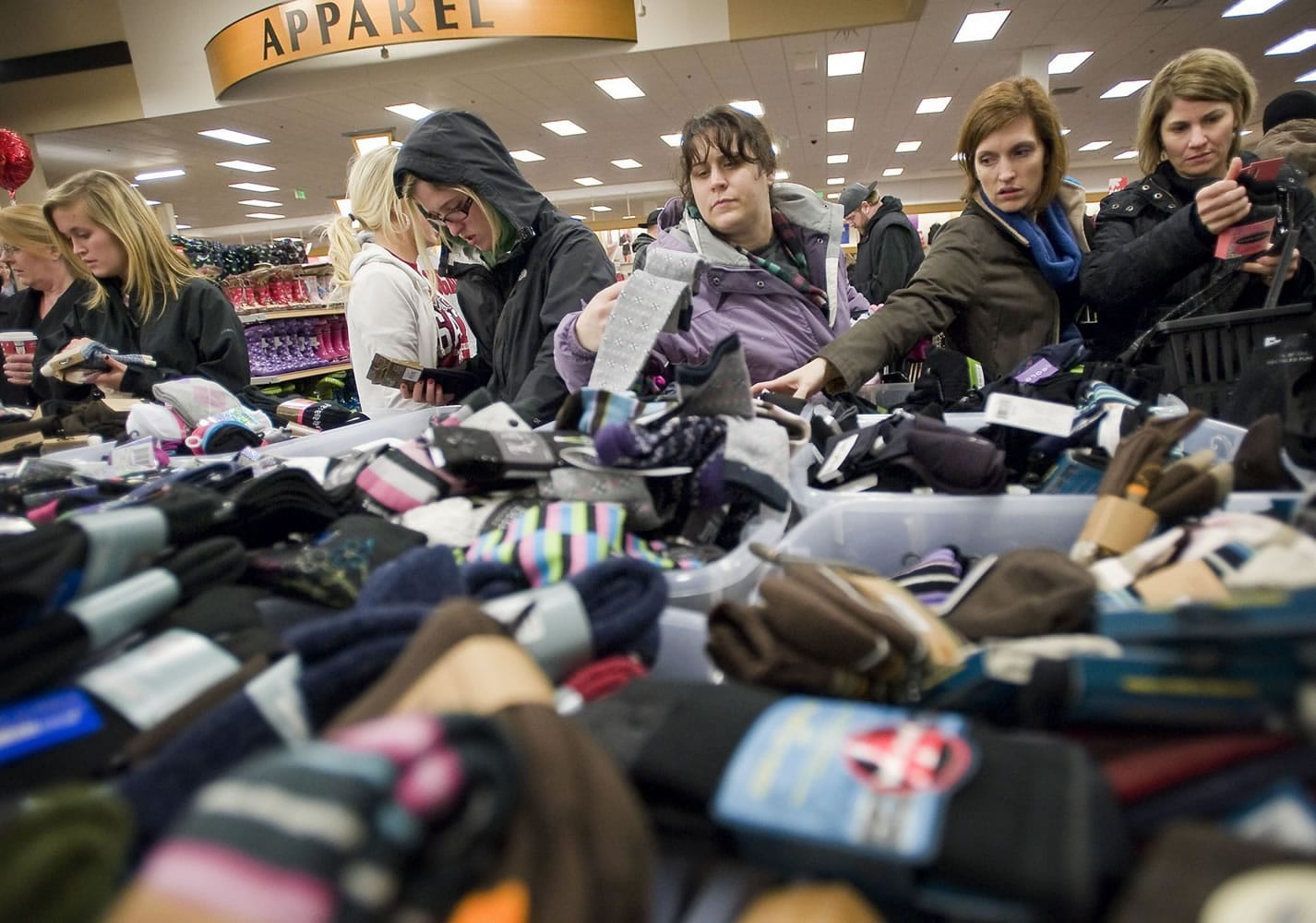 A crowd swarms around the half-priced socks displayed on tables inside Fred Meyer's Salmon Creek store just after the 5 a.m.