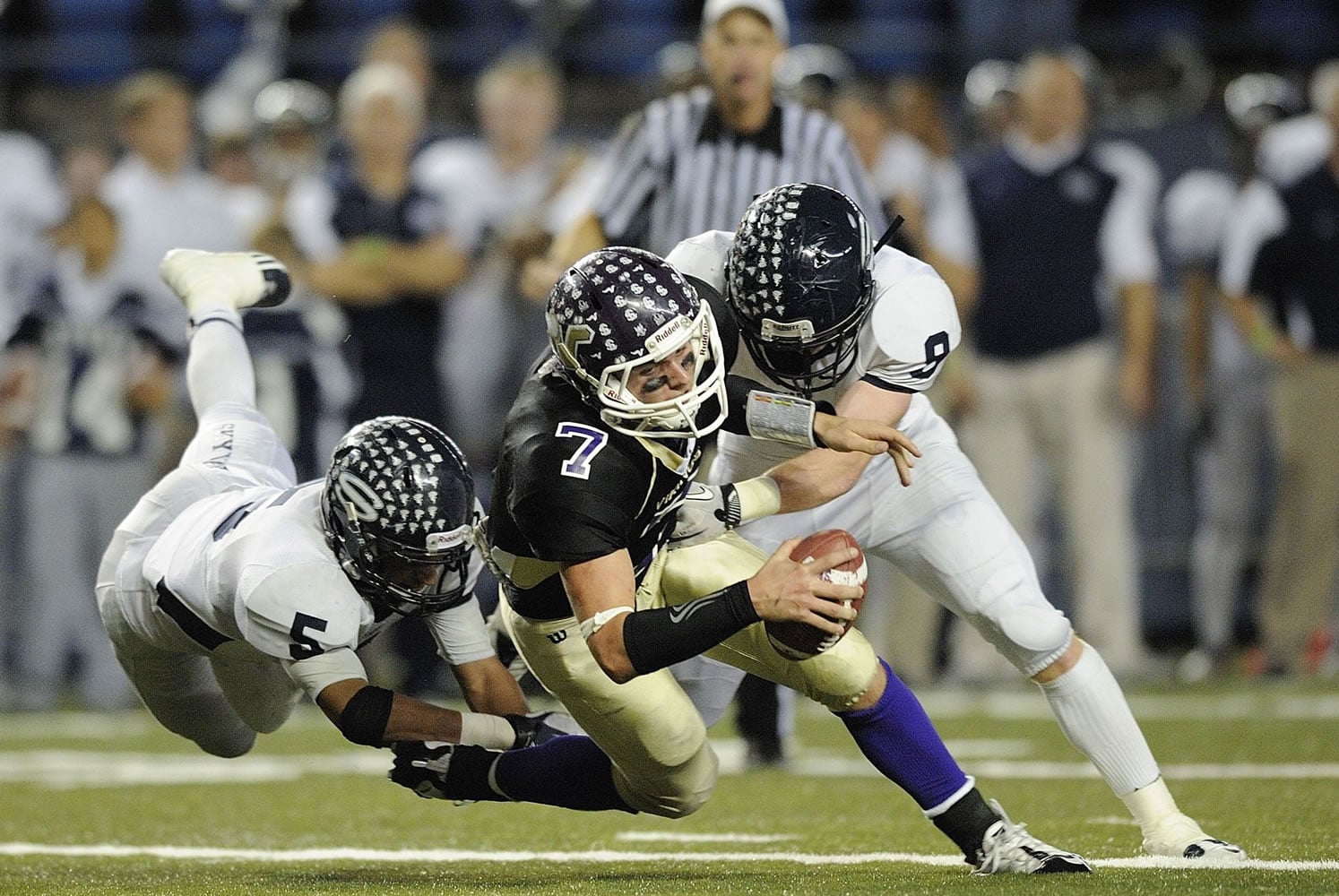 Skyview defenders Xavier Norman (5) and Hayden Shuh (9) sack Lake Stevens quarterback Jake Nelson during Saturday's Class 4A state semifinal at the Tacoma Dome.