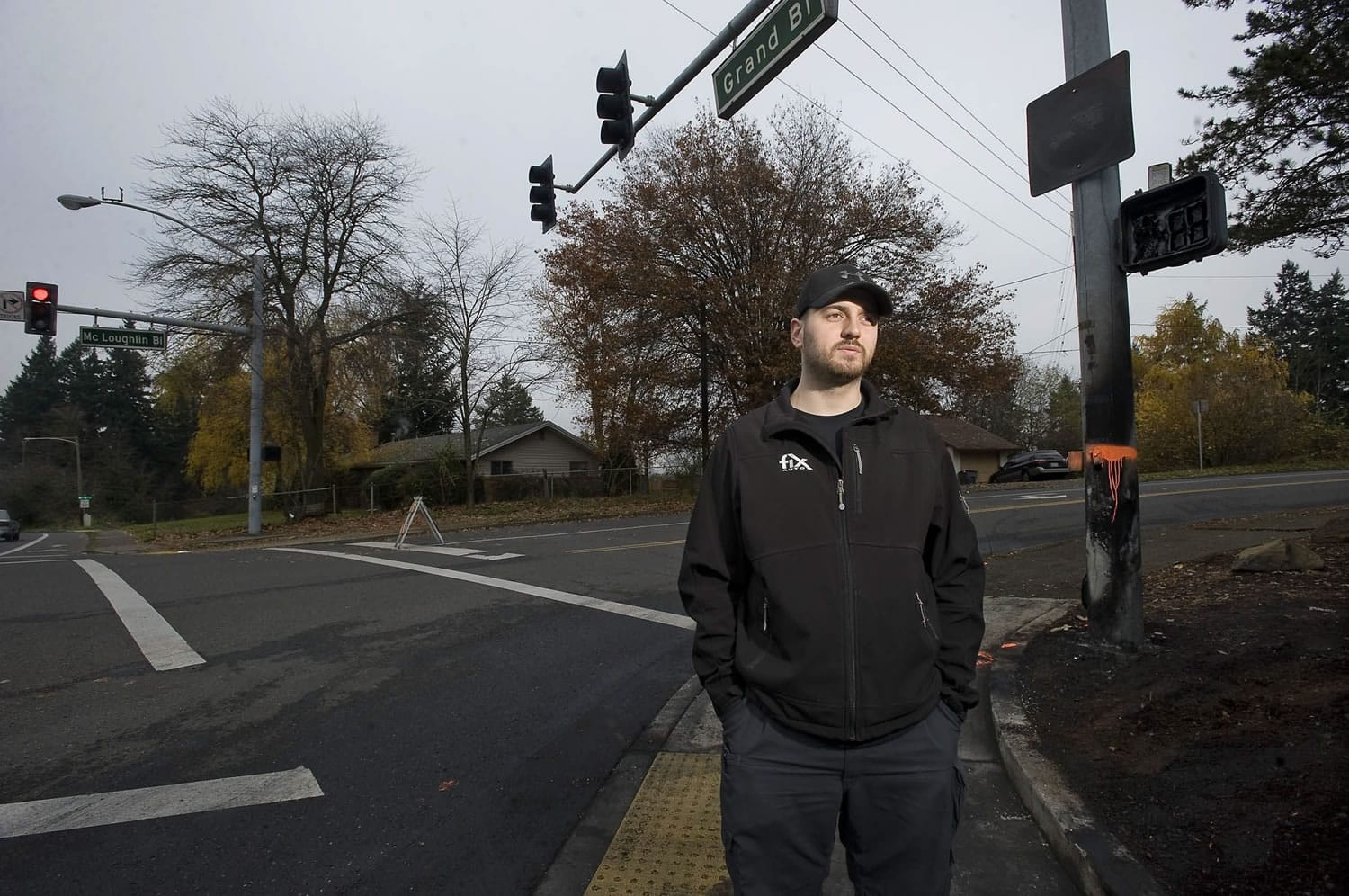 James Bray stands at the corner where he rescued the driver of a burning car that hit a utility pole at 2 a.m. Saturday.