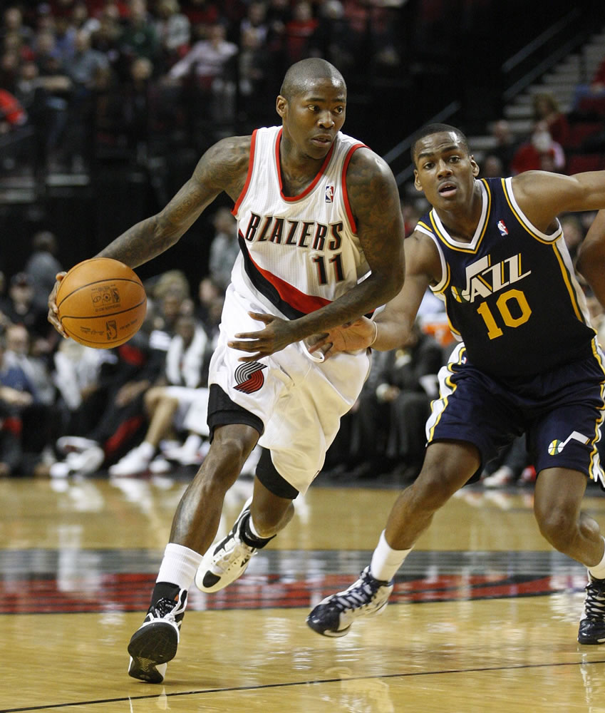 Jamal Crawford (11) drives past Utah's Alec Burks. Crawford scored eight points in his first game in Portland as the Blazers won the preseason game 110-90 on Monday.