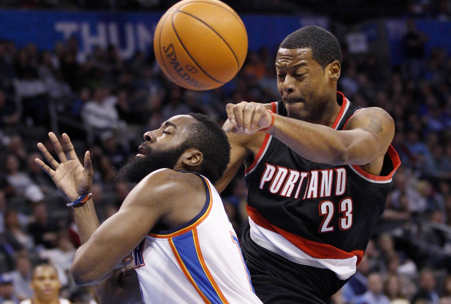 James Harden, left, loses the ball as he drives to the basket in front of Portland's Marcus Camby (23) in the Blazers' 103-93 win.