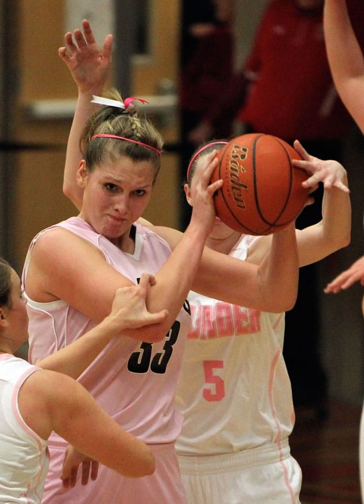 Mountain View defenders swarm Camas post Jenka Stiasna (33) during Friday's game, which was Camas' annual Hoops for Pink cancer awareness night.