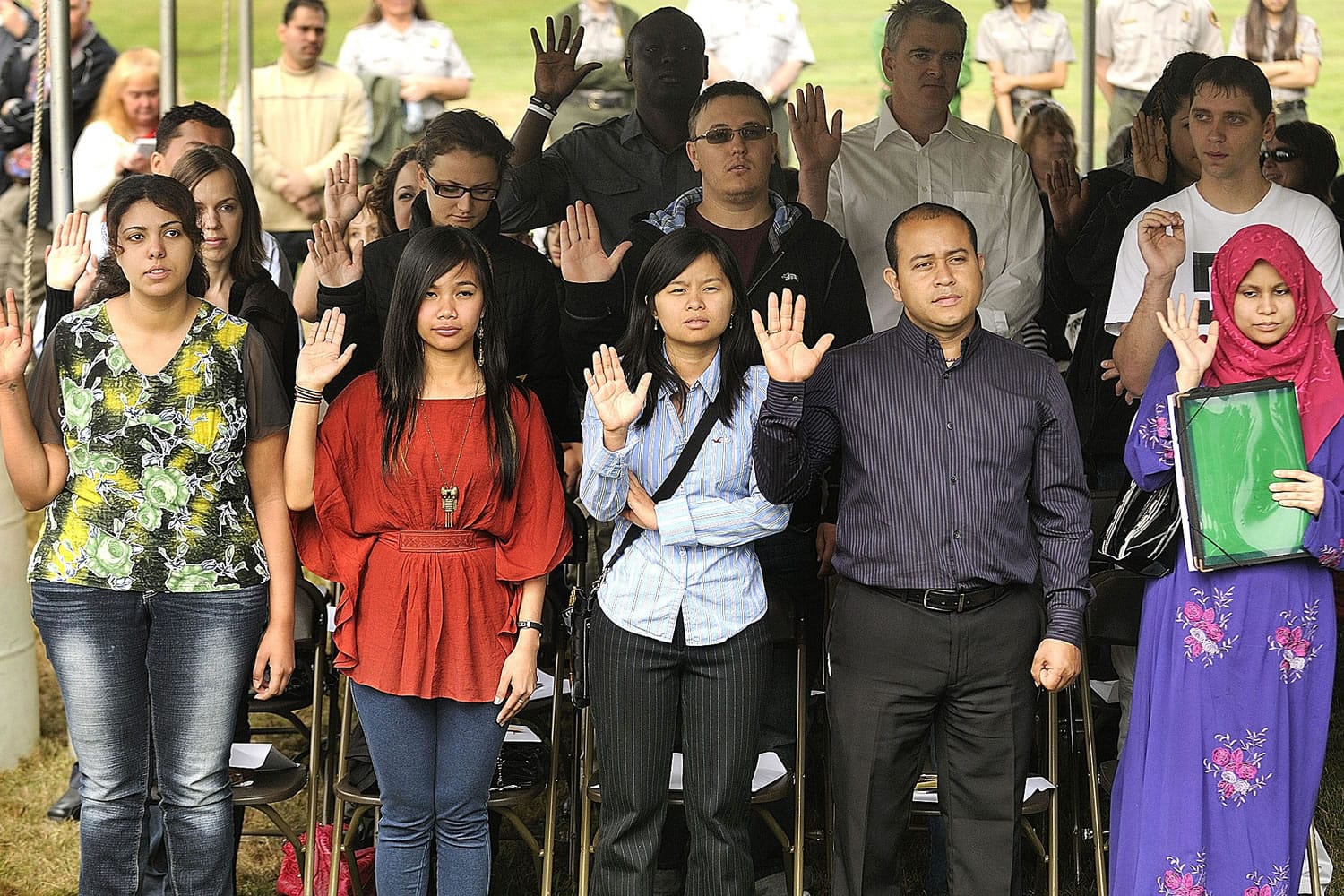 From left to right, Mervat William, Charmaine Balangue, Anh Thy Le, Oscar Hernandez Juarez and Aylesha Choudhury, take the oath of allegiance at a Naturalization Ceremony Friday in Vancouver.