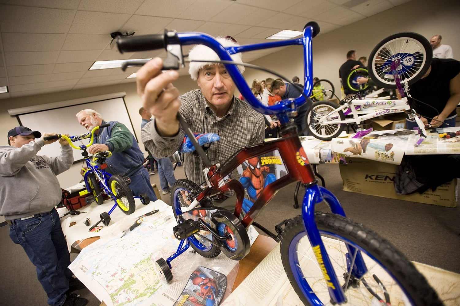 Dean Large, sales manager at Waste Connections, on Thursday builds a bike to be donated to needy children.