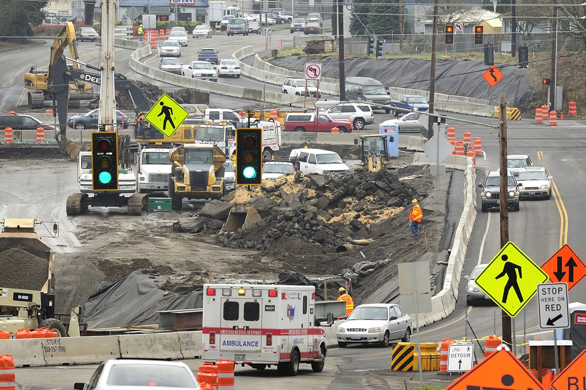 Motorists on Monday make their way through a rearranged intersection at St. Johns Boulevard and state Highway 500, where construction has temporarily eliminated all turns from the highway to St. Johns. Crews are transforming the intersection into a freeway-style interchange, which will send St. Johns up and over the highway on a new bridge.