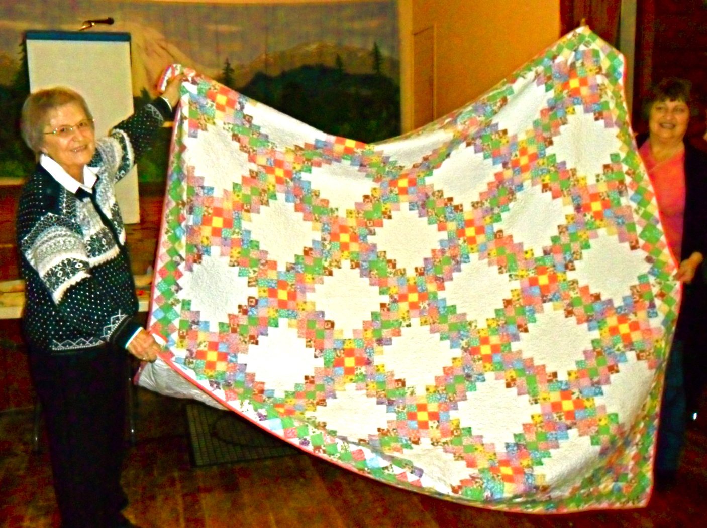 Amboy: Jackie Whiting, right, helps her mother, Rotha Whiting, hold the quilt that Rotha won in the North Clark Historical Museum quilt raffle.