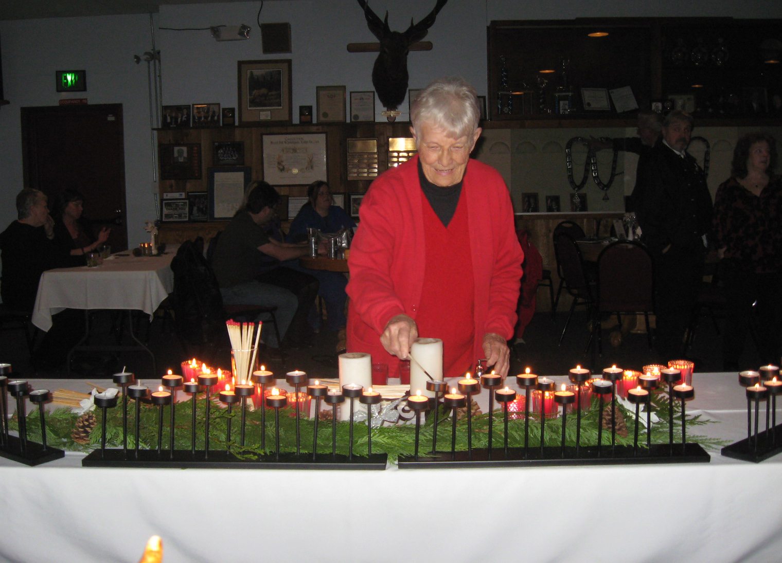 Battle Ground: Event coordinator Kay Beasley of the Battle Ground Elks Lodge lights a candle in memory of deceased Elks members.