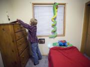 Darian Sund, 9, searches for a pencil in his bedroom so he can draw at his home in Walnut Grove.
