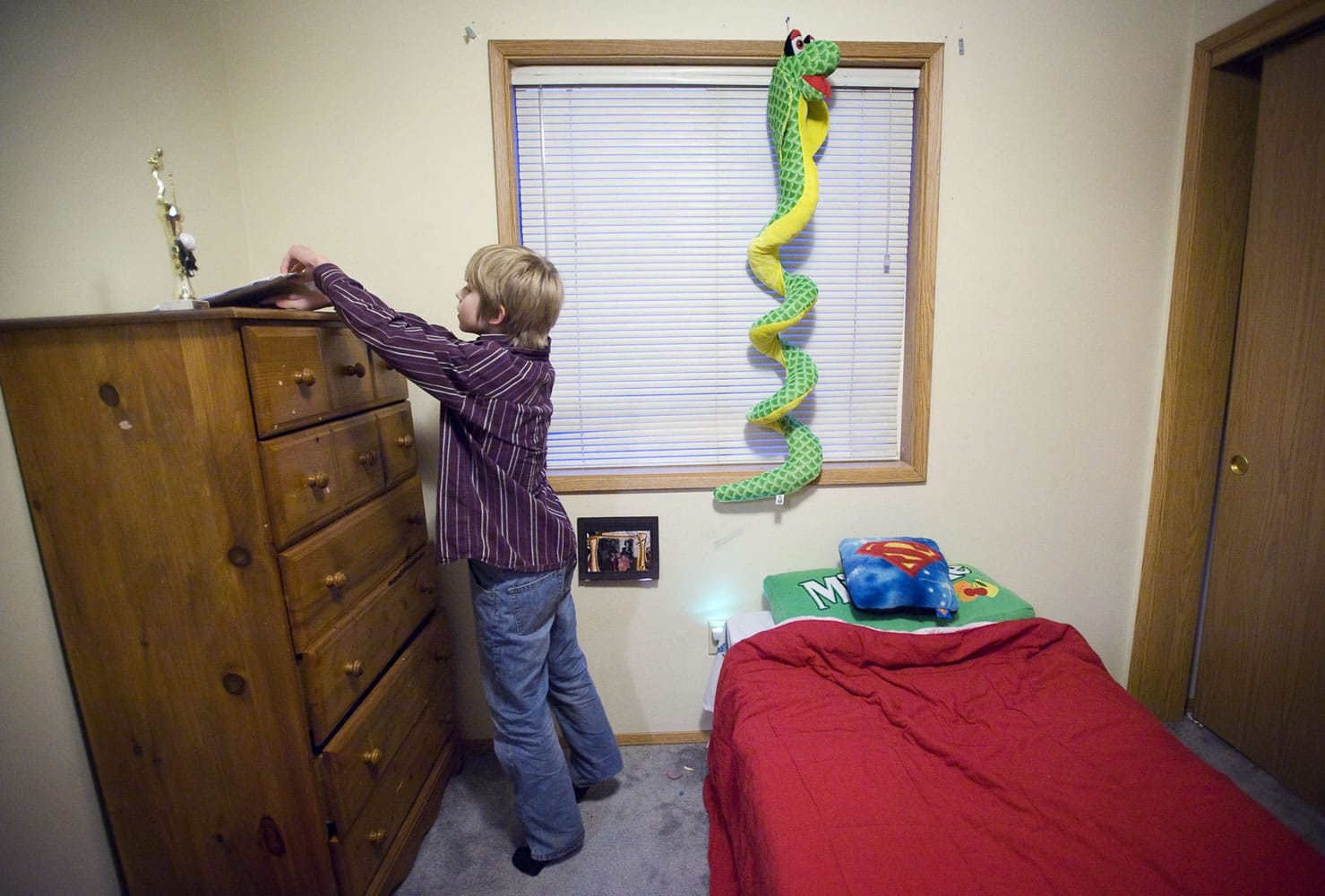 Darian Sund, 9, searches for a pencil in his bedroom so he can draw at his home in Walnut Grove.