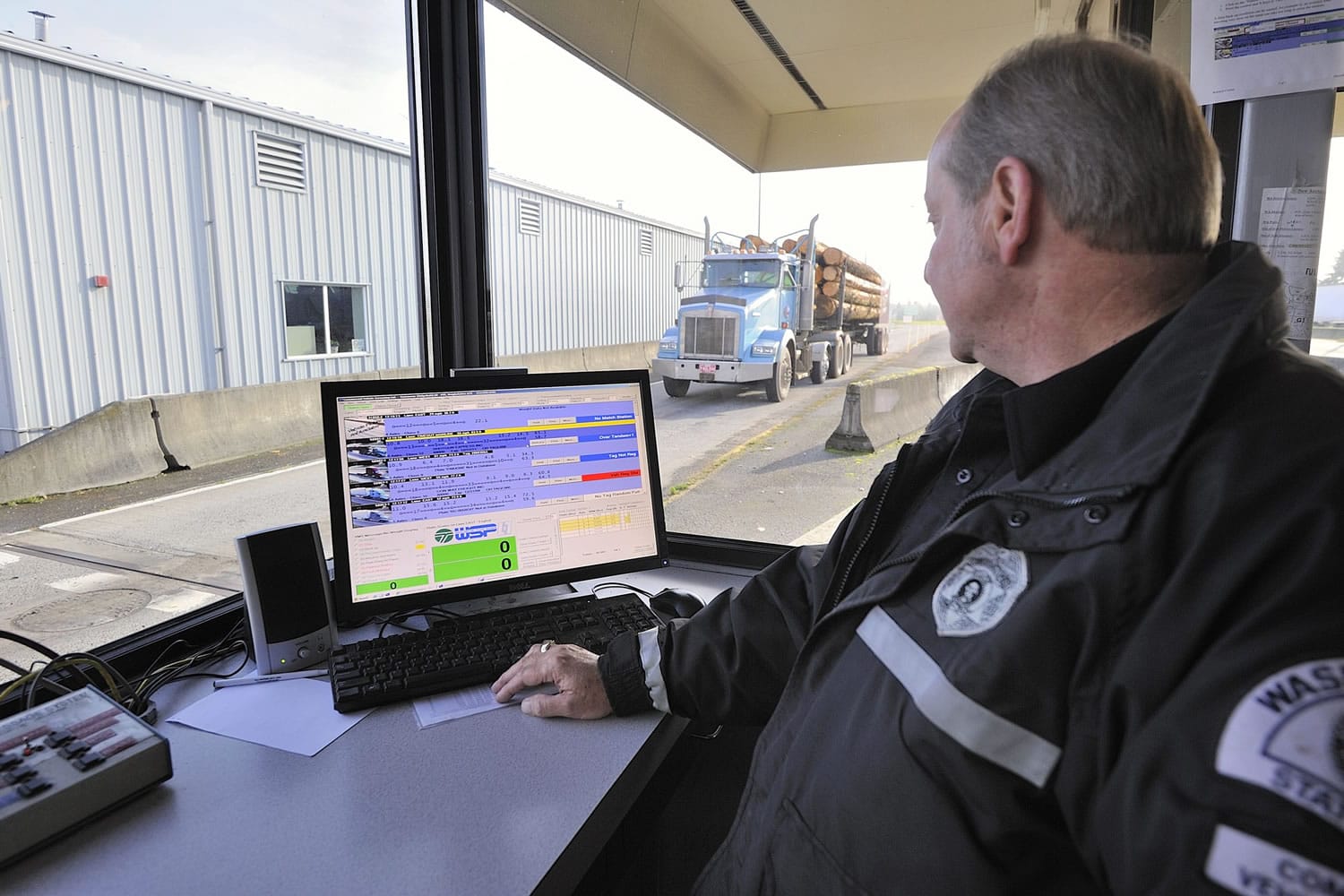 Commercial vehicle enforcement officer Robert Schultheis with the Washington State Patrol uses a computer with new software to monitor big rigs on Interstate 5 in Ridgefield.
