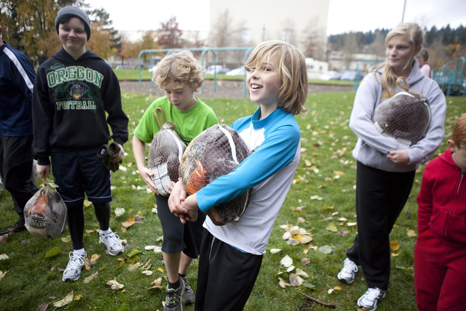 Whiley Middlemas, 9, center, and Oliver Clauson, 9, in green, were among the 20 runners who won a frozen turkey during a raffle at the Clark County Running Club's annual Turkey Trot at Marine Park on Saturday.