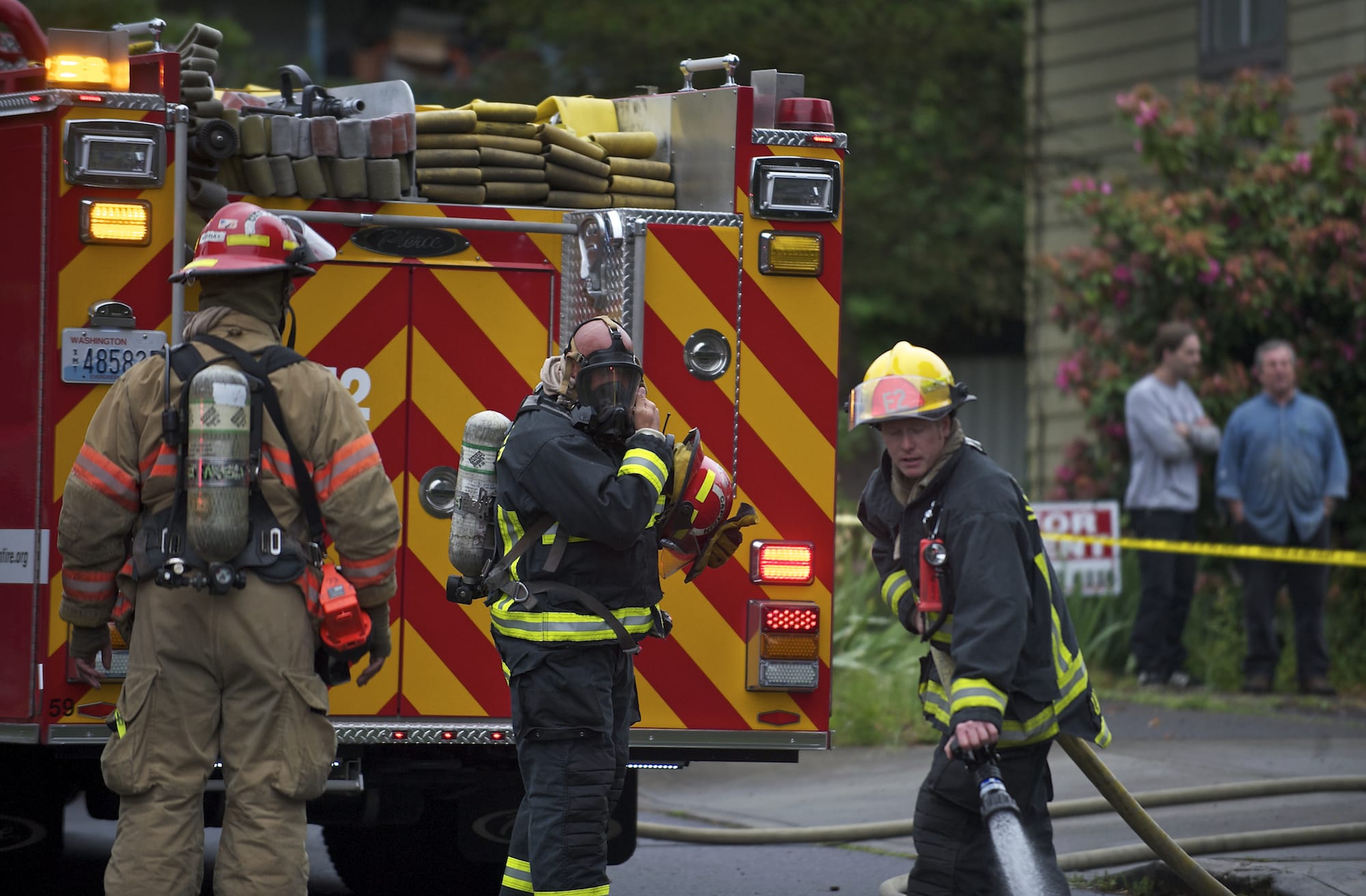 Fire fighters respond to an apartment fire where a man was trapped on the second floor until a neighbor -- himself an off-duty firefighter -- helped him down with a ladder before crews arrived on Monday.