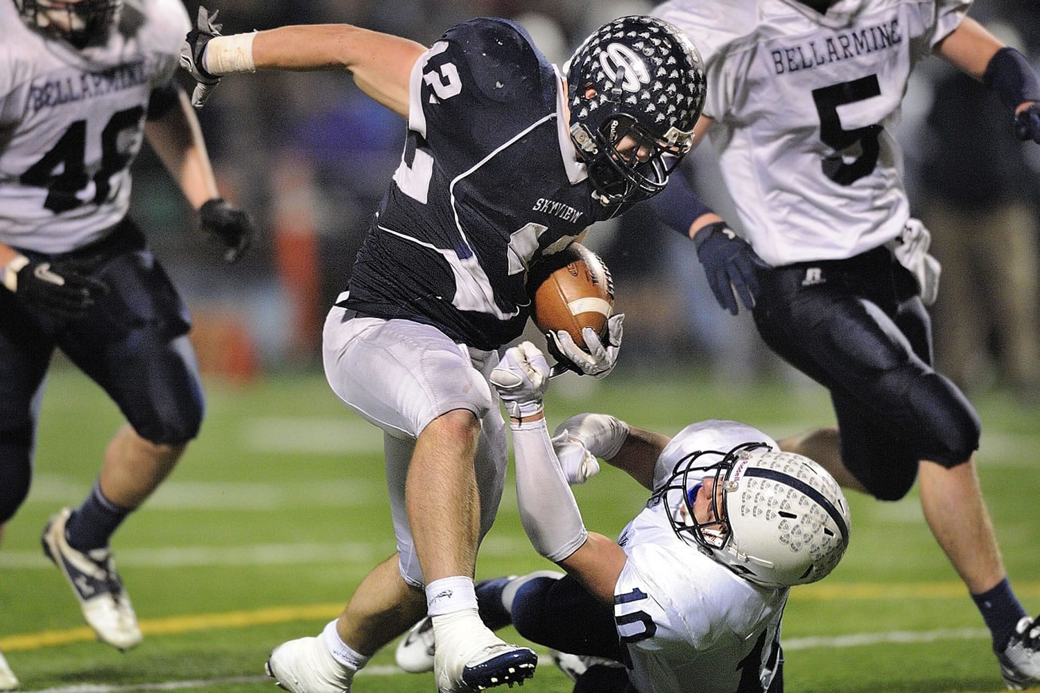 Skyview's Parker Henry runs over Drew Griffin of Bellarmine Prep to pick up a first down during the second half Saturday.