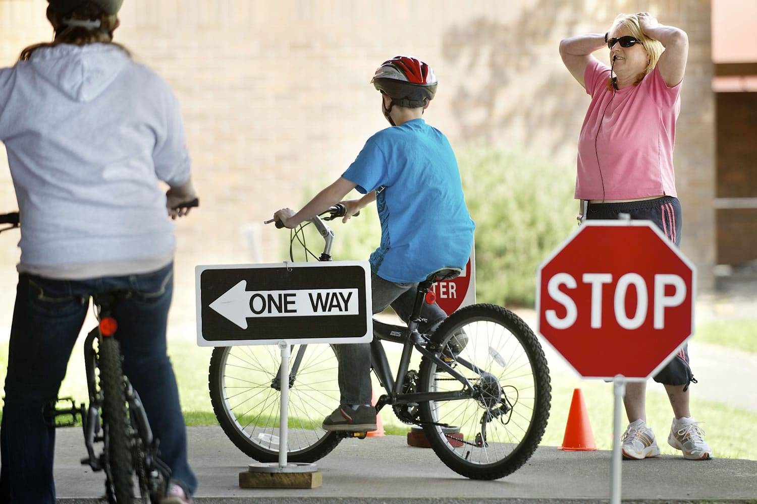Stephanie Vanveen, a physical education teacher at Wy'east Middle School, reacts as Jordan Hornbeck, 13, fails to yield and signal during a bicycle safety class at the school Thursday. The class was part of a two-week unit teaching middle-schoolers hand signals, the rules of the road and bicycle safety.