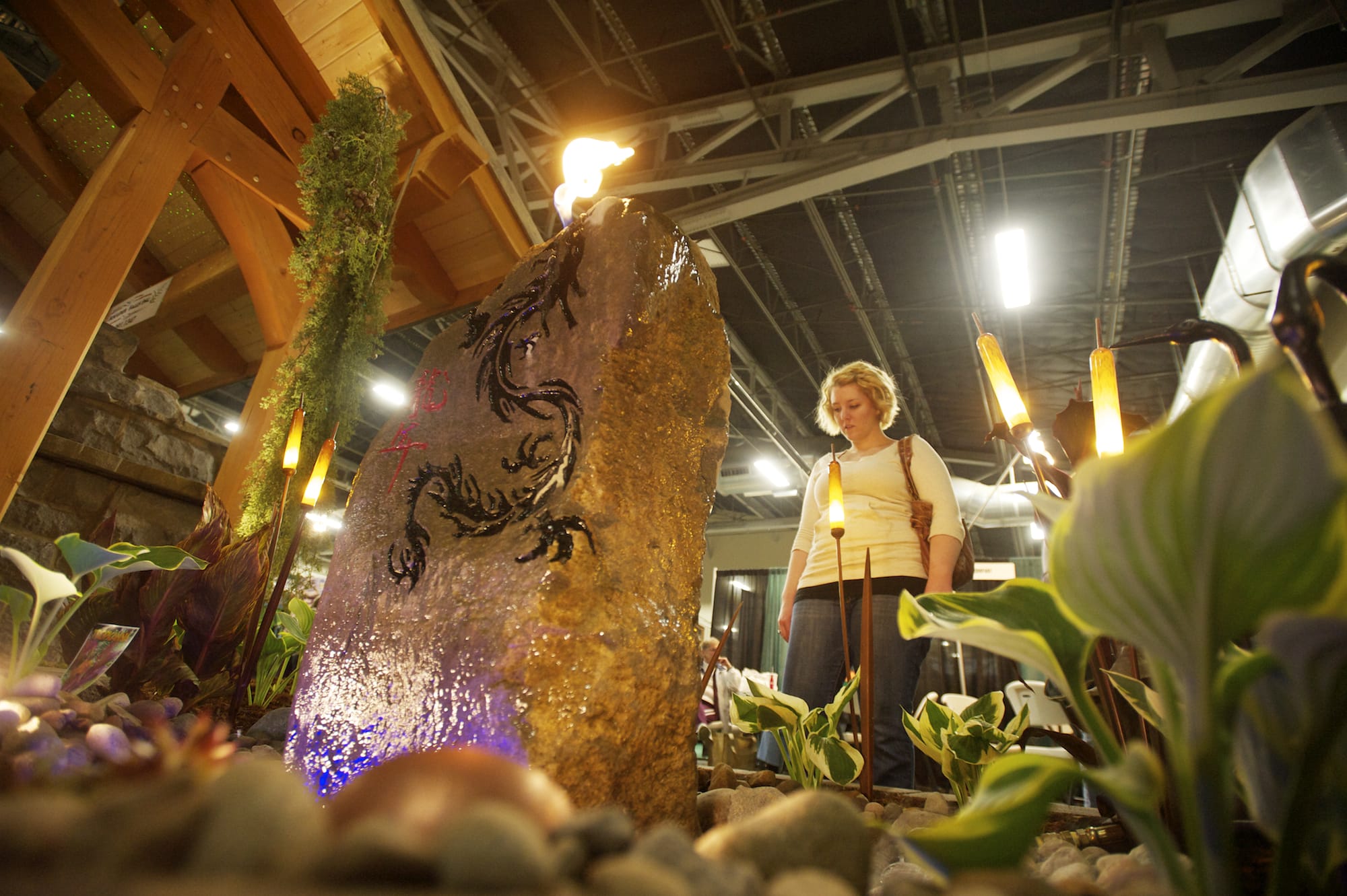 Amy Crockford, 24, of Vancouver looks at the Boulder Falls Inc. display Saturday at the Clark Public Utilities Home &amp; Garden Idea Fair, which continues today at the Clark County Event Center at the Fairgrounds.