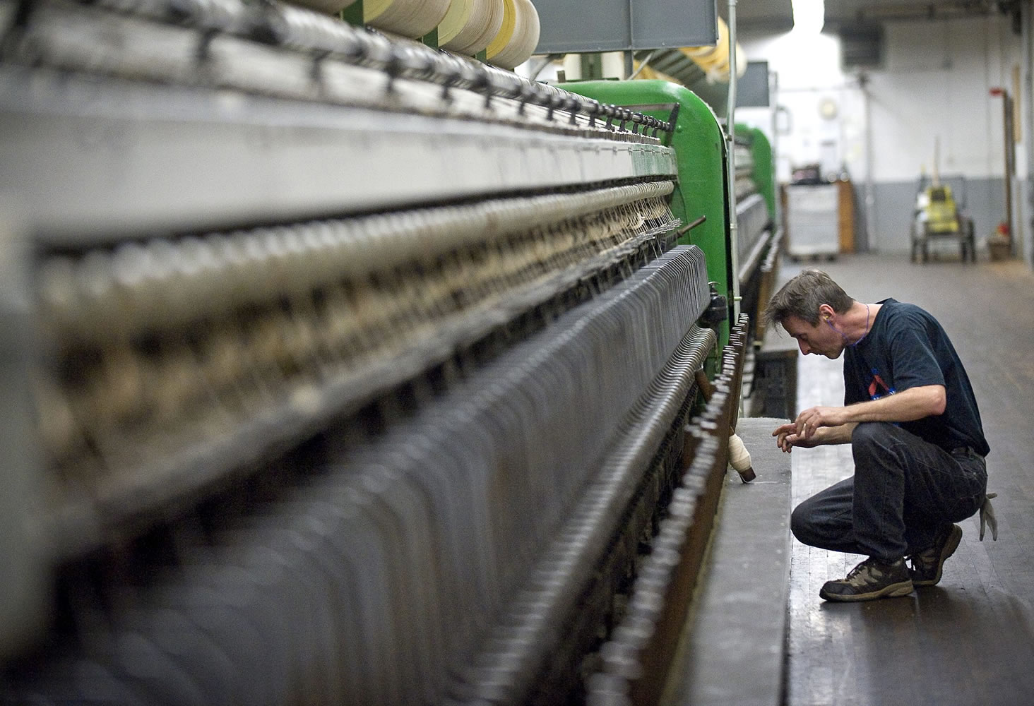 General helper Jeff Hamilton works inside the spinning house at the Pendleton Woolen Mill in Washougal.