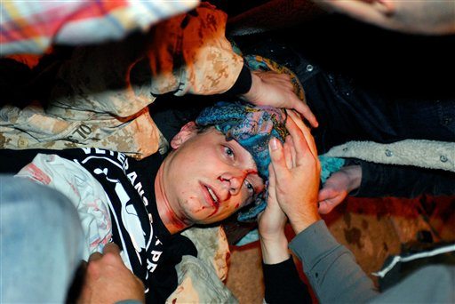 In this photo taken Tuesday, Oct. 25, 24-year-old Iraq War veteran Scott Olsen lays on the ground bleeding from a head wound after being struck by a by a projectile during an Occupy Wall Street protest in Oakland, Calif. Olsen has become a symbol for protesters in Portland.