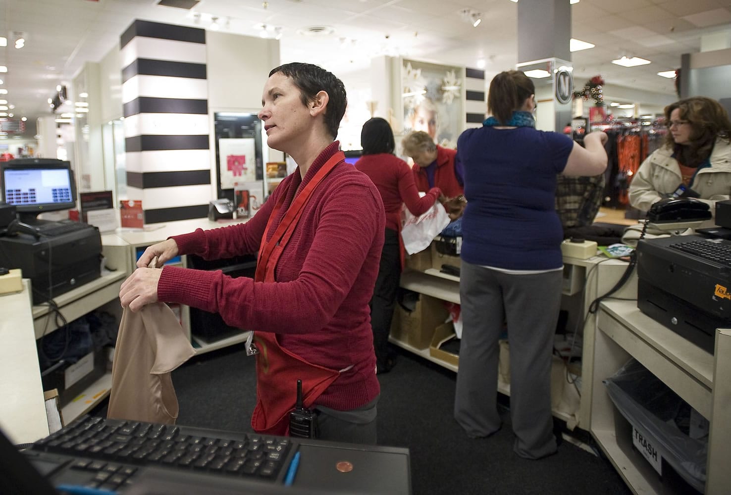 J.C. Penney sales associate Melissa Glogosh, 41, rings up a customer at Westfield Vancouver mall on Dec. 9.