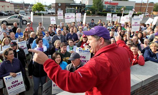 Dave Baughman, cheers on striking teachers gathered to picket in front of Jason Lee Middle School, in Tacoma, Wash. on Thursday, Sept. 15, 2011. Teachers in Washington state's third-largest school district have voted overwhelmingly to remain on strike, in defiance of a judge's order that they return to work. The teachers walked out Tuesday over issues including pay and how job transfers are handled. A state judge issued an order Wednesday that they go back to class, but the teachers refused.