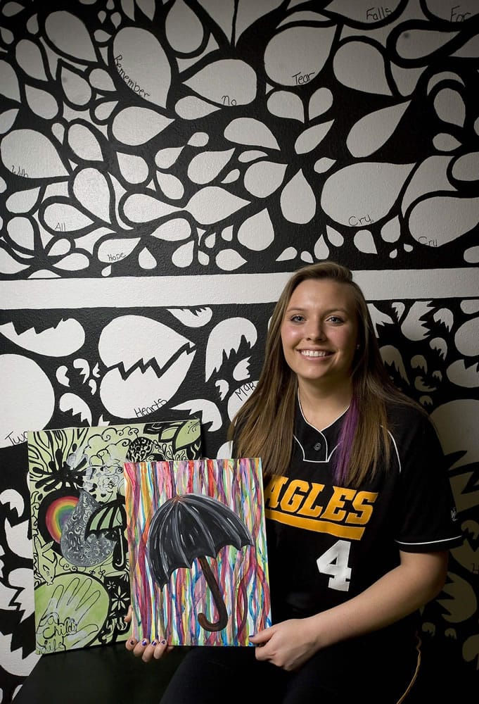 Dusti Blair, a Hudson's Bay softball player, Weber State signee and Vancouver School of Arts and Academics student, poses with her art work in front of a mural that she painted inside her bedroom.